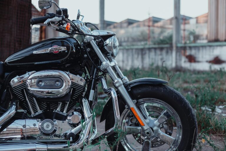 Close-up of a Harley Davidson motorcycle engine and body, parked outdoors.